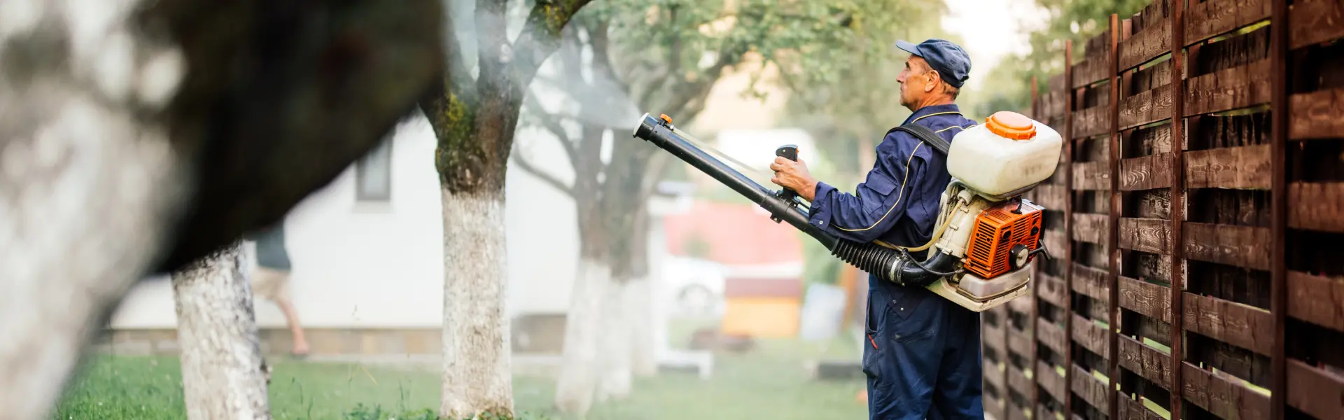 An Animal Remover pest control technician sprays for mosquitoes in Cincinnati