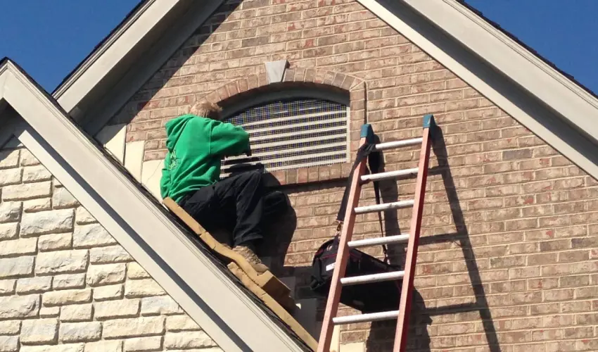 Animal Remover service technician making repairs to a window to prevent wildlife entry