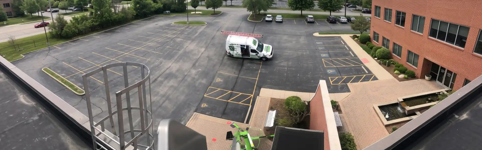 Animal Removal team accessing roof to implement exclusion repairs on a commercial building.