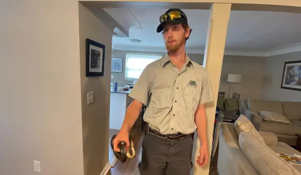 Animal Remover technician holding a snake. Check out the Animal Remover gallery to see animal remover services in Cincinnati.