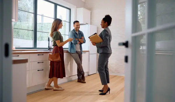A real estate agent talking to prospective home buyers. Call or contact Animal Remover in Cincinnati if you're planning to buy a home with animal or pest damage.