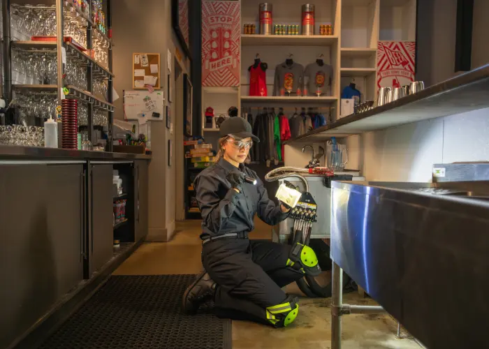 An Animal Remover pest technician performing a pest inspection in a Cincinnati business